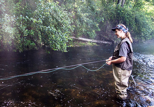 Young fisher lady on the Rose River